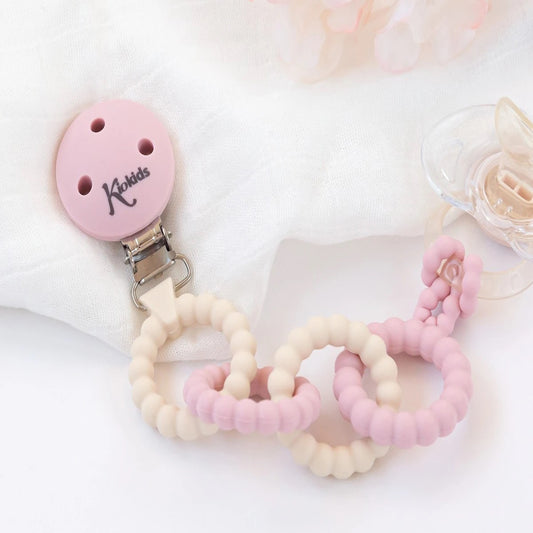 Broche de silicona rosa para chupetes